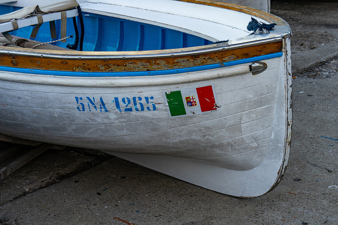 The Italian nautical flag on a rowboat hauled out in Marina Grande on the island of Capri, Italy.