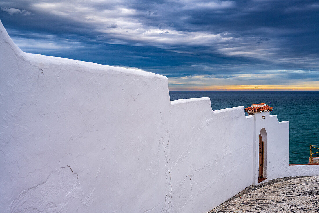 Coastal architecture with a stunning sea view and a dramatic atmosphere.