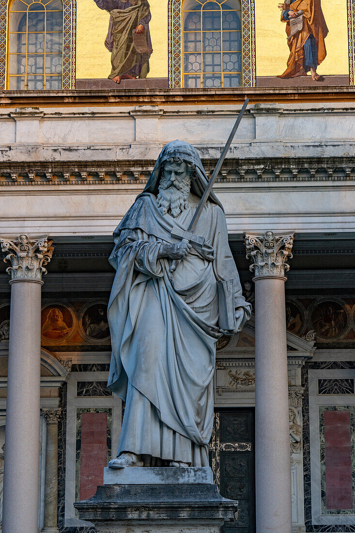 The statue of St. Paul in front of the Basilica of St. Paul Outside the Walls, Rome, Italy.