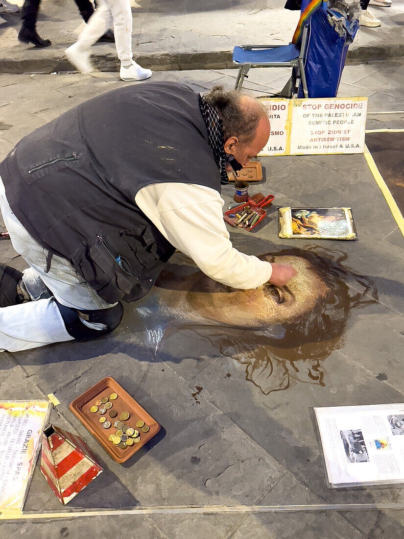 An artist reproduces classic paintings with chalk on the flagstones of a street in Florence, Italy, working only for tips. The drawings are cleaned off the street every night.