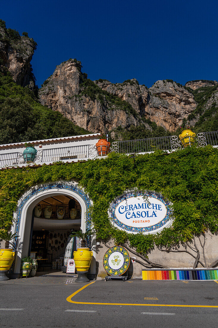 The entrance of a ceramic shop on the Amalfi Coast road in Italy. The rugged Lattari Mountains are behind.