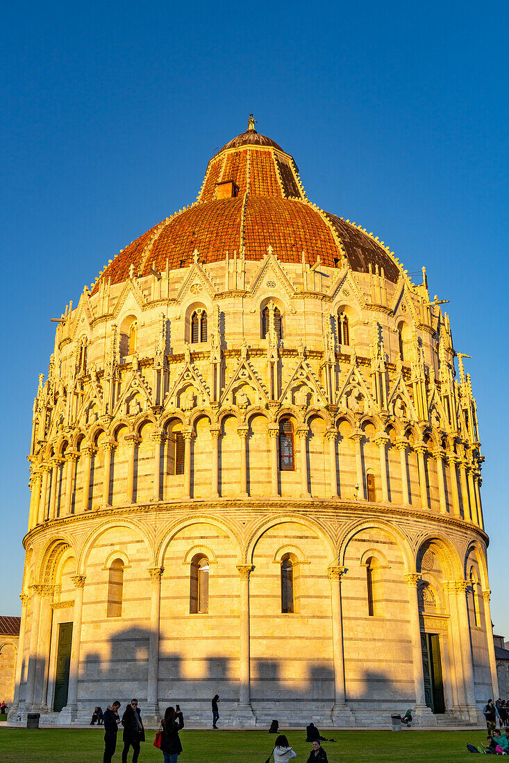 Baptistery of St. John of the Pisa Cathedral in the Piazza dei Miracoli in Pisa, Italy. The top half of the baptistery is Gothic style, while the lower half is Romanesque.