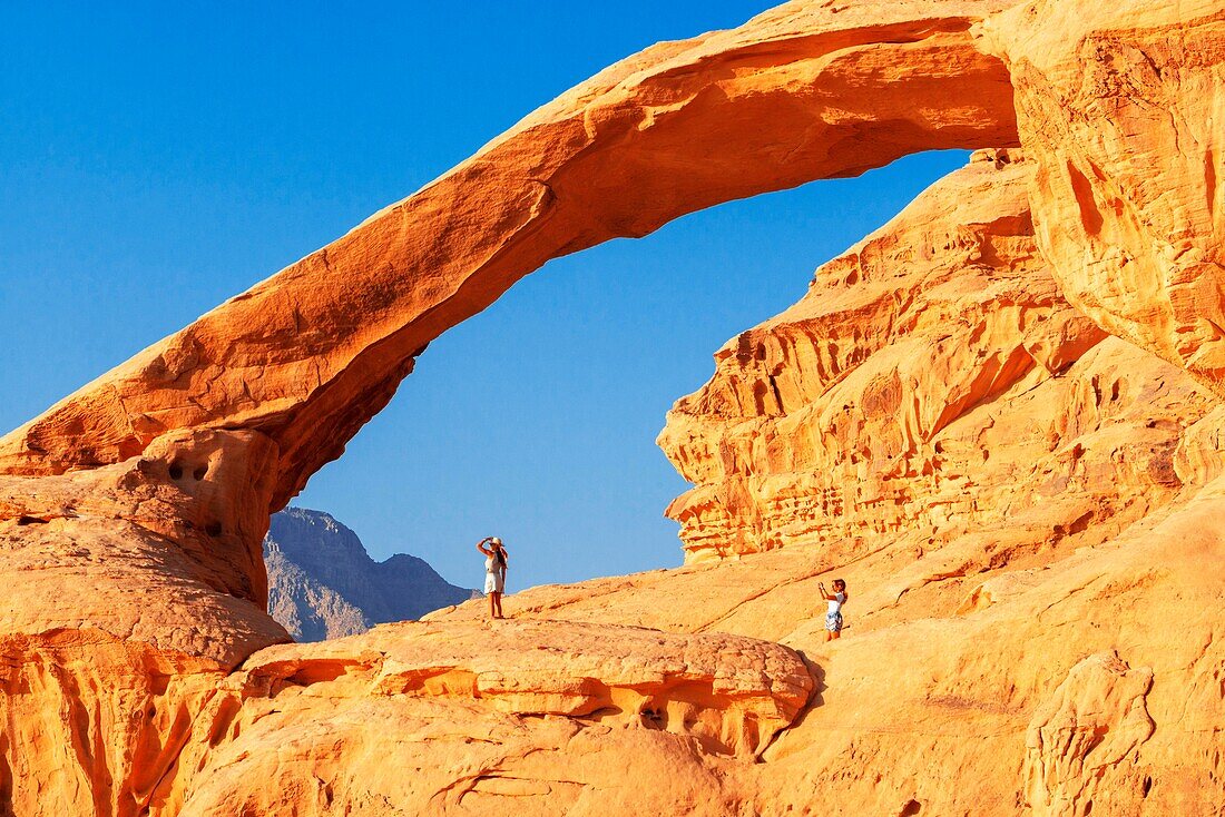 Hiking at rock-arch Al Kharza or Al Borg Alsagheer Wadi Rum, Jordan