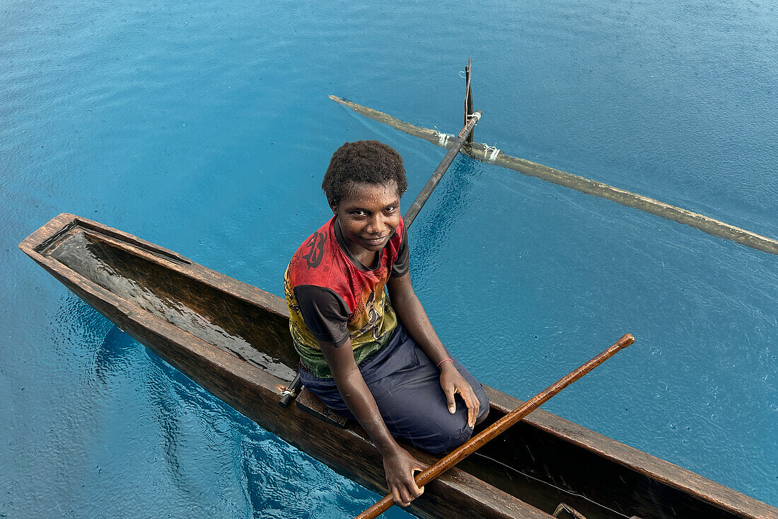 Residents of Tungelo Island in their traditional dugout canoes, New Ireland province, Papua New Guinea