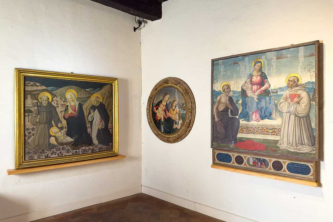 The Podesta Chapel of the Palazzo Comunale or city hall of the medieval city of San Gimignano, Italy. L-R: The Madonna, St. Francis and St. Dominic Worship the Child, by Pier Francesco Florentino, circa 1487; Madonna and Child, Young St. John and an Angel by Sebastiano Mainardi, circa 1490-1500 and Madonna and Child with St. Jerome and St. Bernard, by Sebatiano Mainardi, circa 1502.