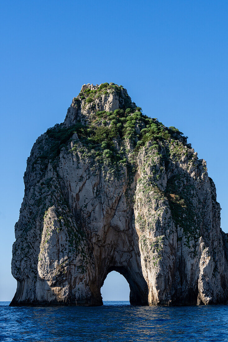 The Farallons or faraglioni, sea stacks off the coast of the island of Capri, Italy. Mezzo, with its sea arch.