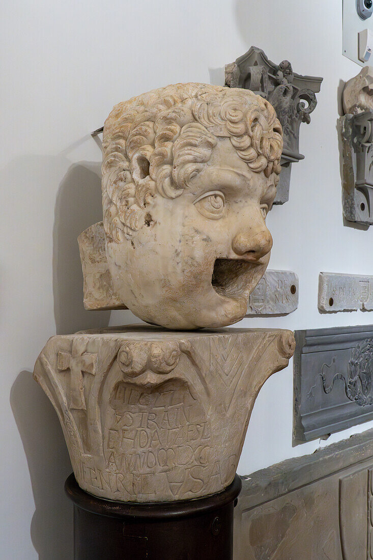 Carved marble gargoyle head in Lapidarium storico in the Duomo Museum in Florence, Italy. 16th Century A.D.