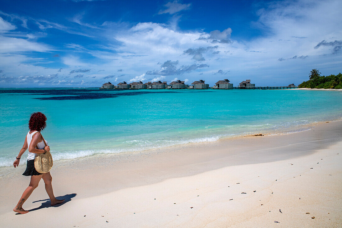 Walking on the white beach of the the luxury hotel Six Senses Laamu maldives luxury resort villas, Laamu Atoll region Maldives