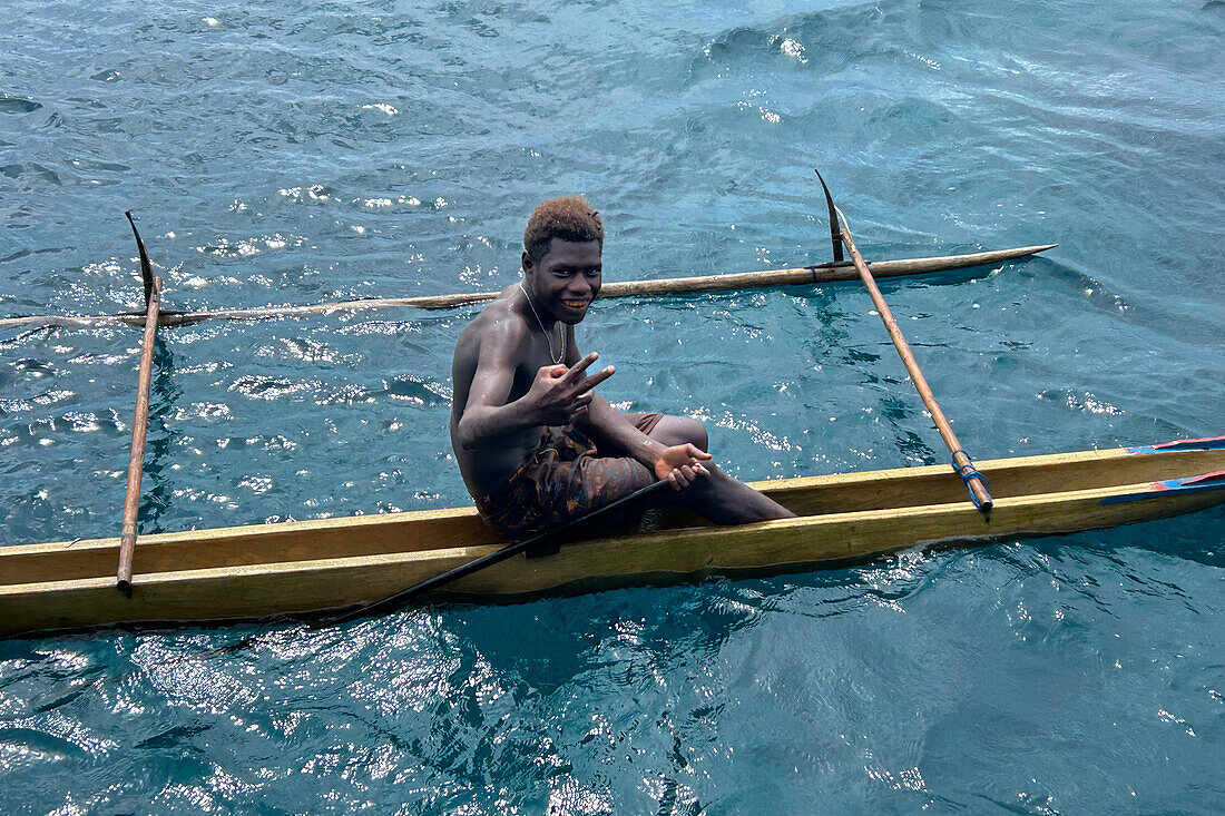 Residents of Tungelo Island in their traditional dugout canoes, New Ireland province, Papua New Guinea