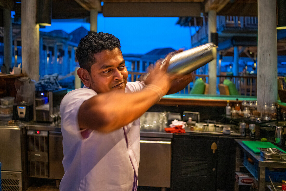 Cocktail barman in the bar restaurant of the Six Senses Laamu maldives luxury resort villas, Laamu Atoll region Maldives