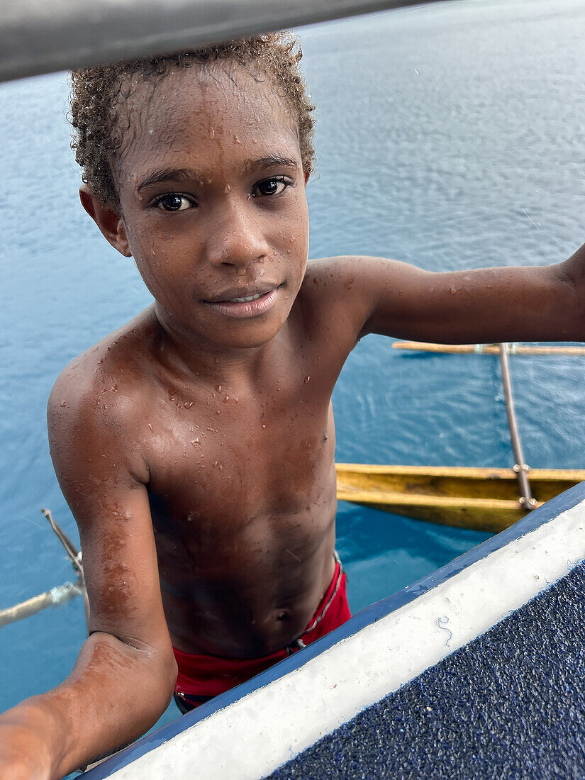 Residents of Tungelo Island in their traditional dugout canoes, New Ireland province, Papua New Guinea