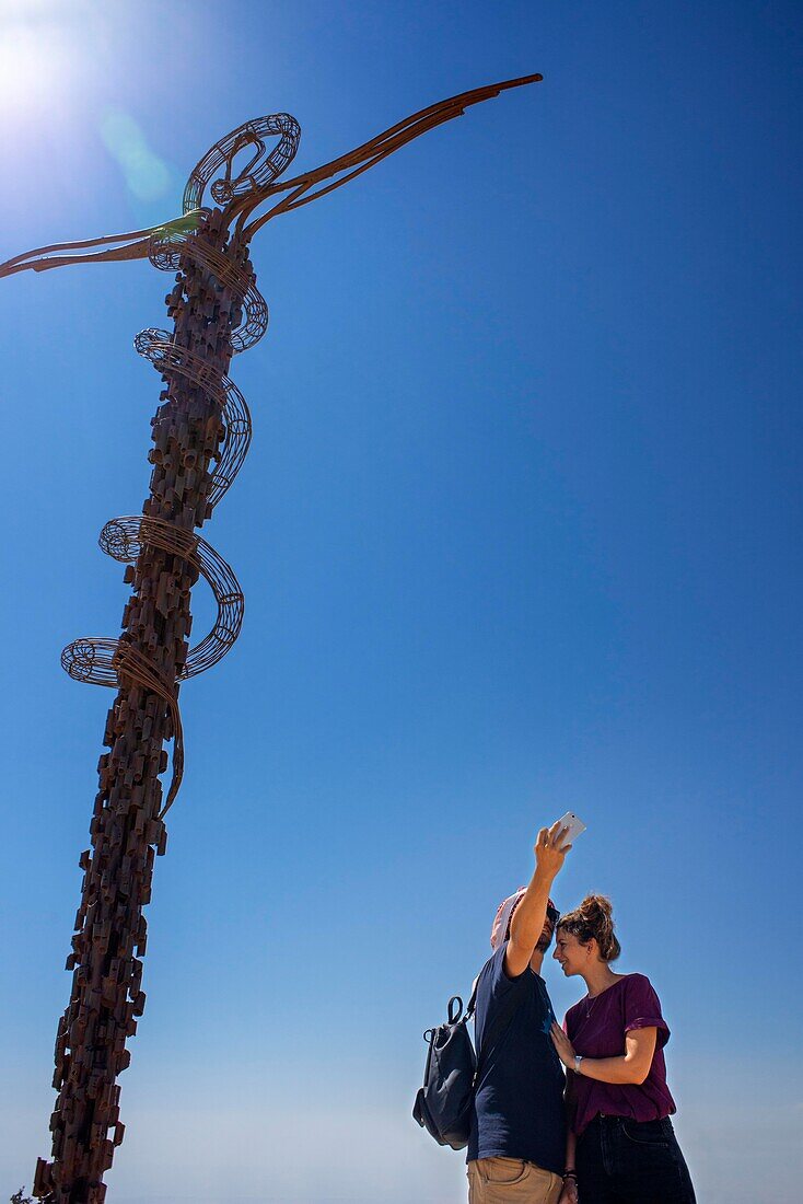 Tourist couple in The memorial cross at Mount Nebo, Jordan