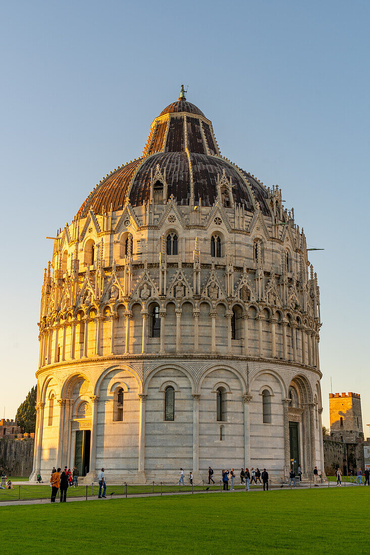 Baptistery of St. John of the Pisa Cathedral in the Piazza dei Miracoli in Pisa, Italy. The top half of the baptistery is Gothic style, while the lower half is Romanesque.