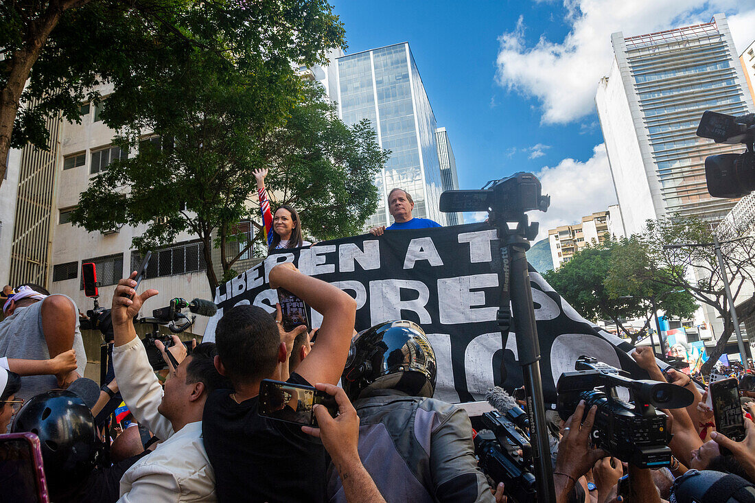 Opposition leader Maria Corina Machado and politician Juan Pablo Guanipa, appear at the opposition rally called by her, in the streets of Caracas.