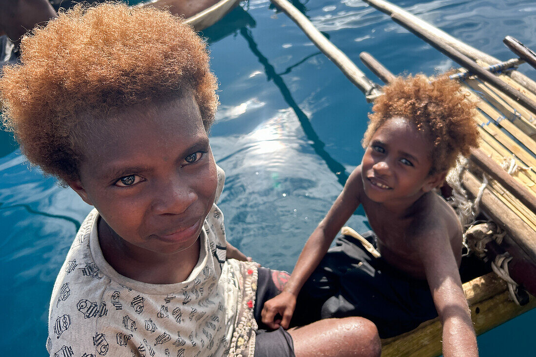 Residents of Vitu Islands in their traditional dugout canoes, Garove Island, Johann Albrecht Harbour, Papua New Guinea