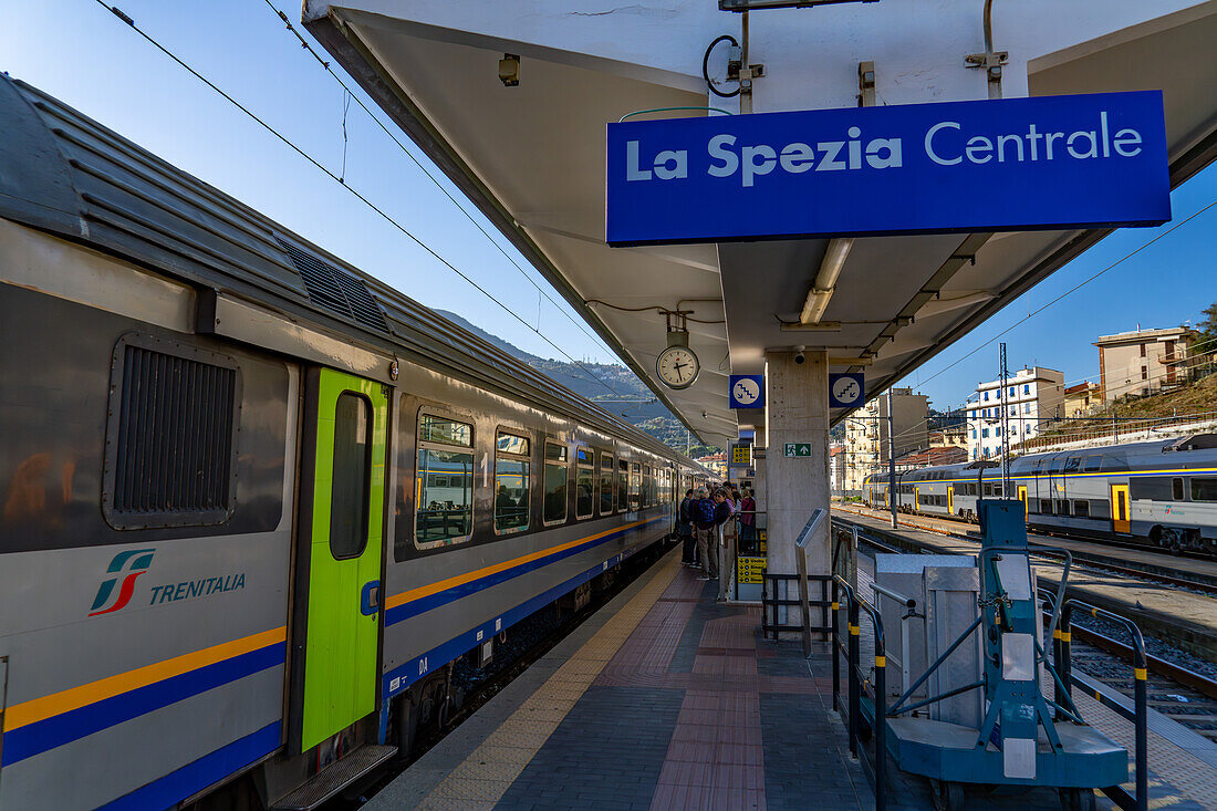 Passengers on the platform by a Trenitalia Pop regional passenger train at the station in La Spezia, Italy. The Pop is a Coradia Stream built by Alstom.