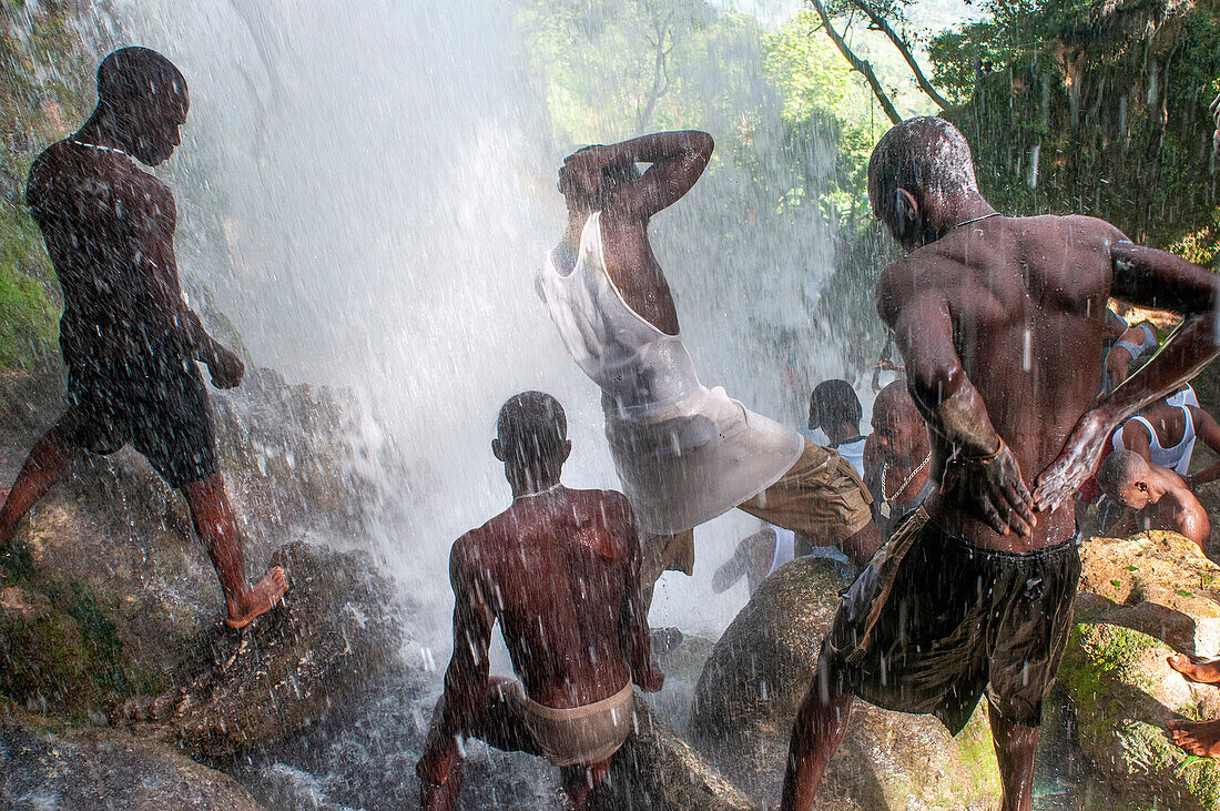 Haiti Voodoo Festival in Saut d'Eau, in Saut d'Eau, Ville Bonheur, Haiti. Thousands of both Vodou and Catholic followers gathered under the Saut d'Eau waterfall in Haiti. The pilgrimage, made by Voodou practitioners and Catholics alike, originated with the sighting of the likeness of the Virgin Mary on a palm leaf close to the falls half a century ago. Catholism and Voodou practices are forever intertwined in its Haitian form. The appearance of a rainbow beneath the falls is said indicate that Danbala - the great lord of the waterfall - and Ayida Wedo - the rainbow - are making love. Fertility