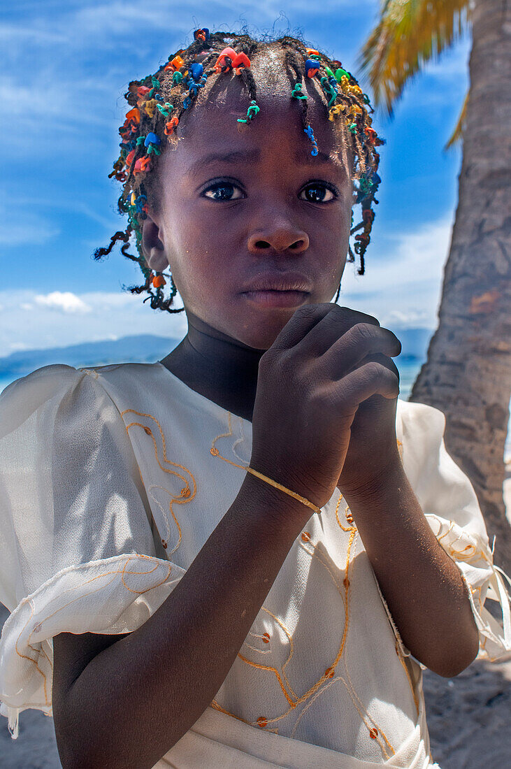 Girl dressed for the Sunday mass in a makeshift church in Cayes-à-L’eau, a fishermen islet located northeast of Caye Grand Gosie, Île-à-Vache, Sud Province, Haiti