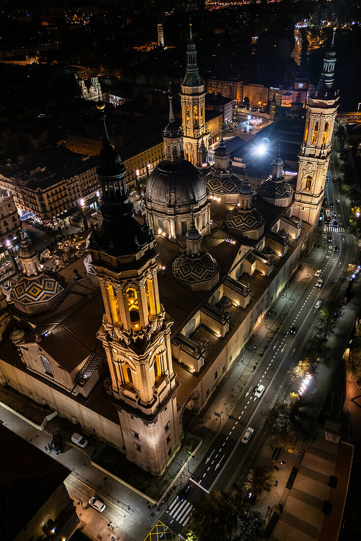 Aerial view of the Cathedral Basilica of Our Lady of the Pillar illuminated at night during Christmas, Zaragoza, Spain