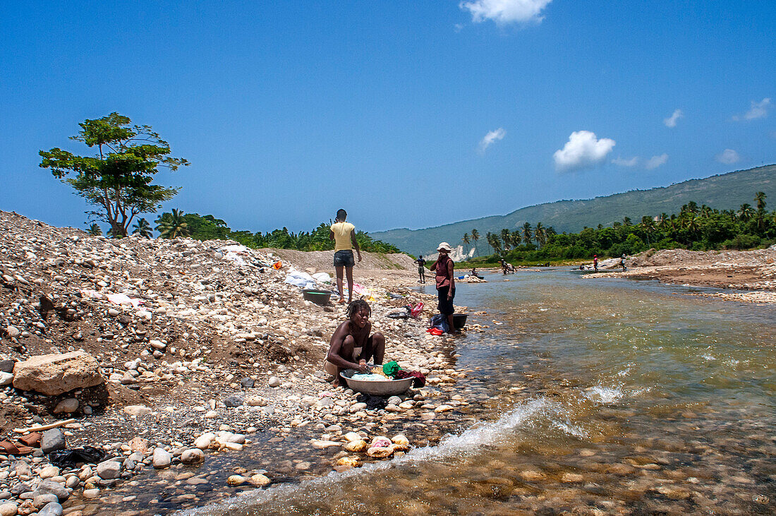 Cleaning clothes on banks of Riviere de la Cosse, Jacmel, Haiti