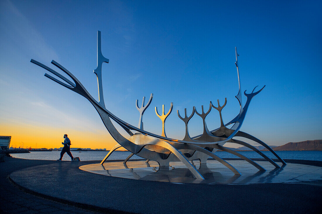 The Sun Voyager sculpture by Jón Gunnar Árnason Reykjavik boat sculpture silhouette at sunset “sun voyager”, or Sólfar, on the waterfront in Iceland