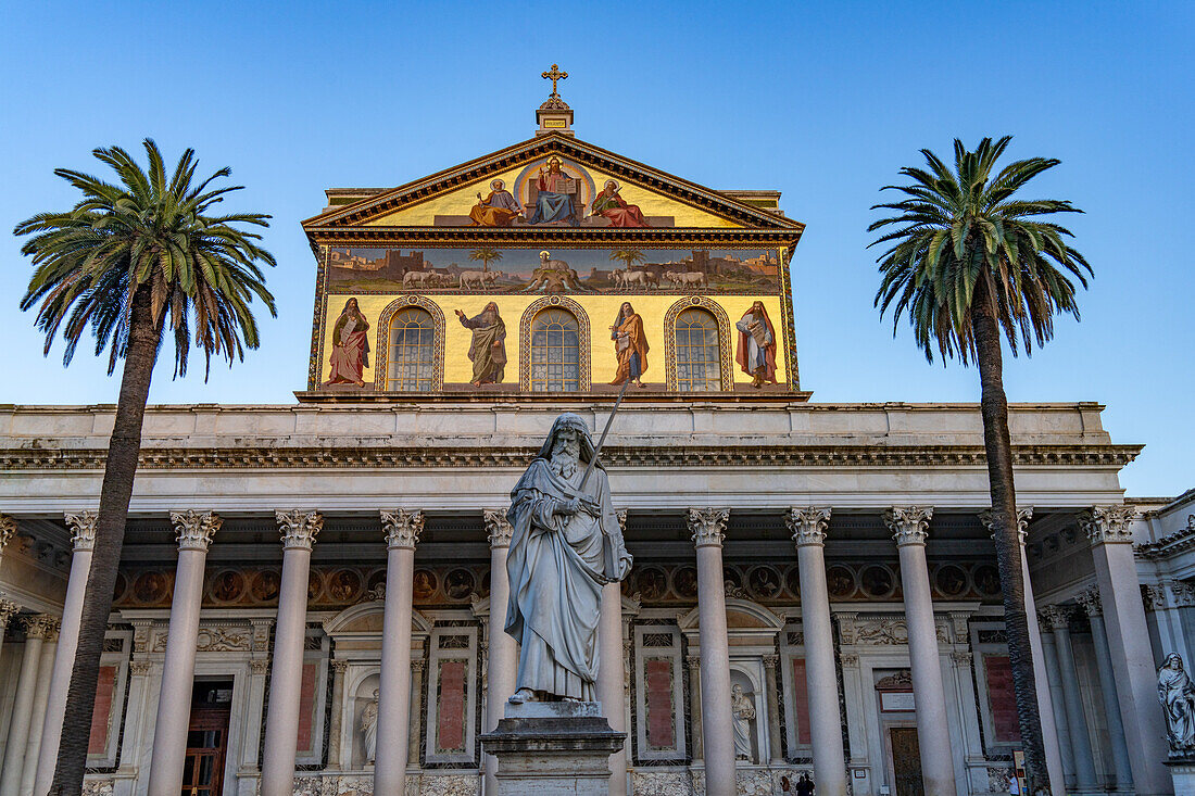 Die Statue des Heiligen Paulus und die Fassade der Basilika St. Paul vor den Mauern, Rom, Italien.