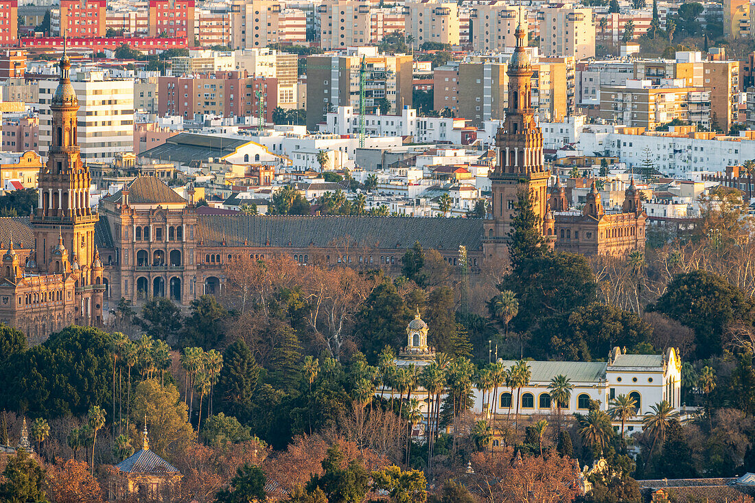 Plaza de Espana showcases stunning architecture and vibrant greenery under a glowing sunset, highlighting the beauty of Seville.