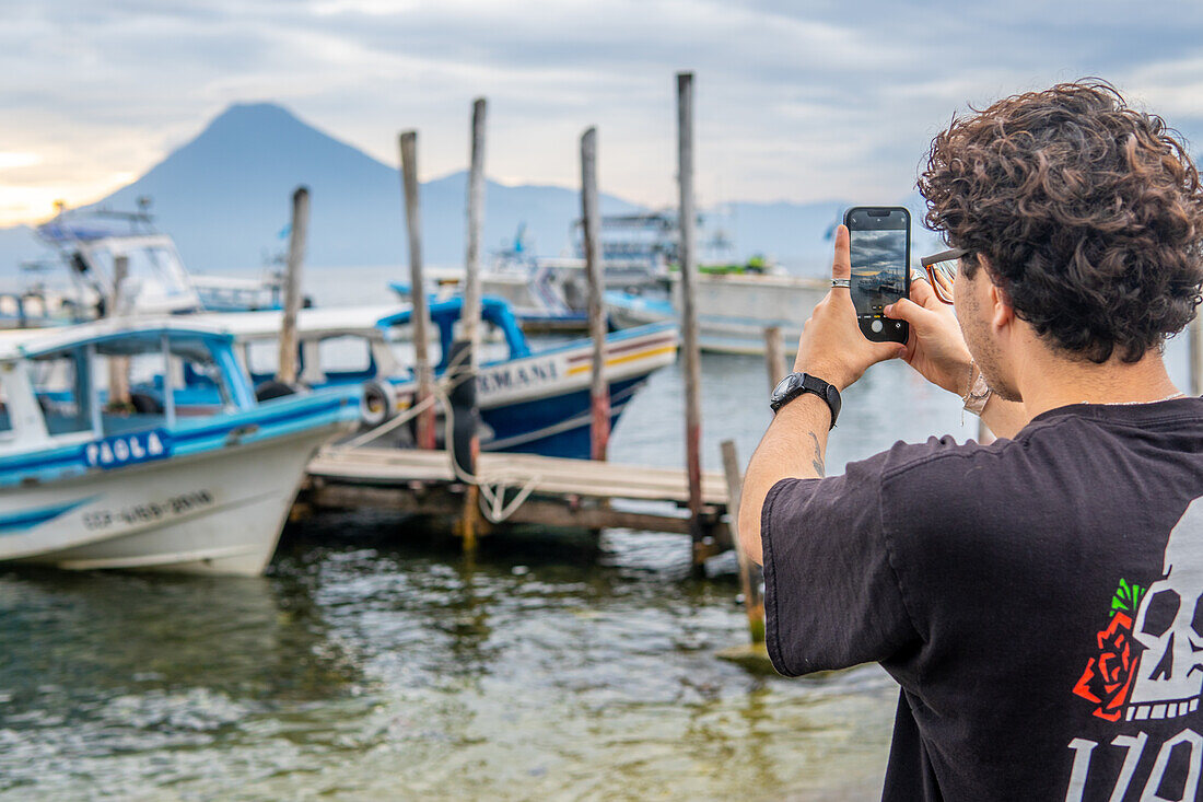 Tourist taking a picture at Lake Atitlan, Guatemala