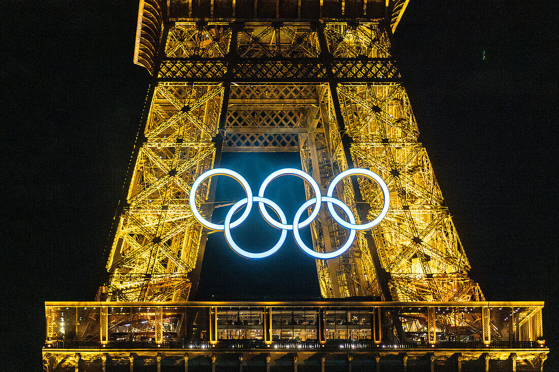 Olympic rings on Eiffel Tower at night, Paris, France