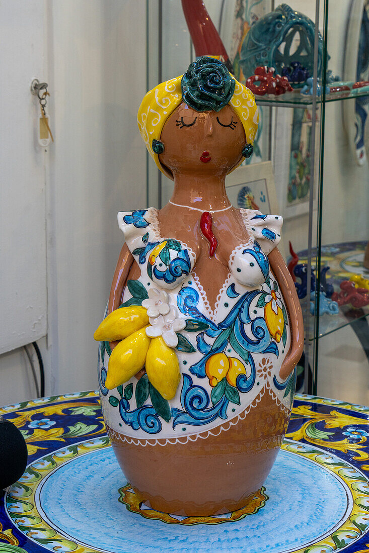 A whimsical ceramic statue of an Italian woman for sale in the Campaniadamare shop in Sorrento, Italy.