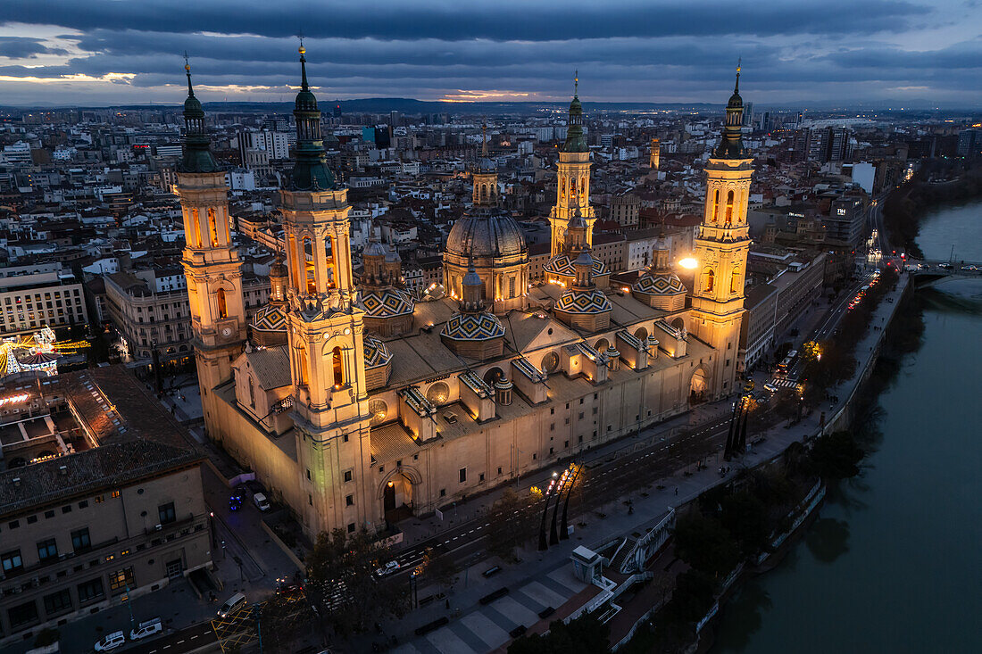 Aerial view of the Cathedral Basilica of of Our Lady of the Pillar and El Pilar square illuminated at night during Christmas, Zaragoza, Spain