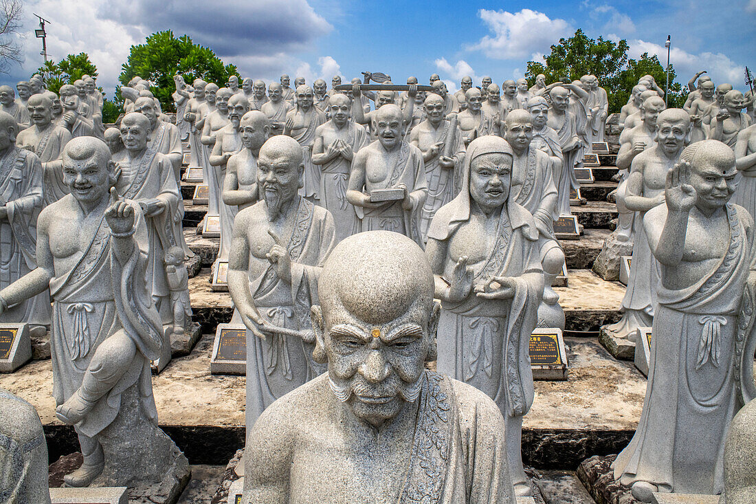 Ksitigarbha Bodhisattva buddhist temple in Bintan, Indonesia - Buddhist umbrella full of 500 statues with expression told of Ksitigarbha Bodhisattvas at the temple in Bintan, Indonesia. Ksitigarbha Bodhisattva is often referred to as the Bodhisattva of the Hell beings because of his vow to not achieve Buddhahood until all the Hells are empty. However, his vow actually encompasses all sentient beings, similar to that of Living Buddha Lien-Shen. He vows to reveal all the secrets of even the hidden teachings, in order to save sentient beings, even if he has to suffer retribution, and the pulveriz