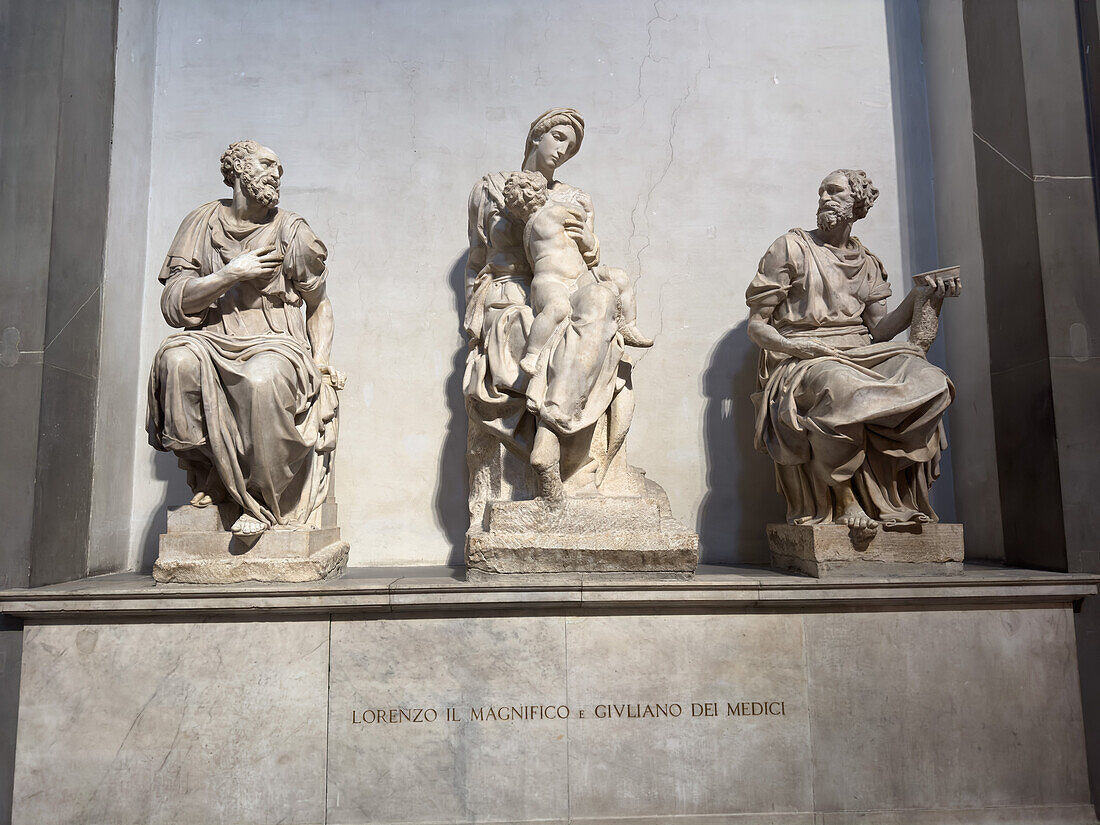 The tomb of Lorenzo the Magnificent de Medici & his brother, Giuliano in the Medici Chapel Museum. Florence, Italy. Located in the New Sacristy. The statues on the sarcophagus are L-R: St. Cosmas by Giomanni Angelo Montorsoli, Madonna and Child by Michelangelo, and St. Damian by Raffaelo de Montelupo.