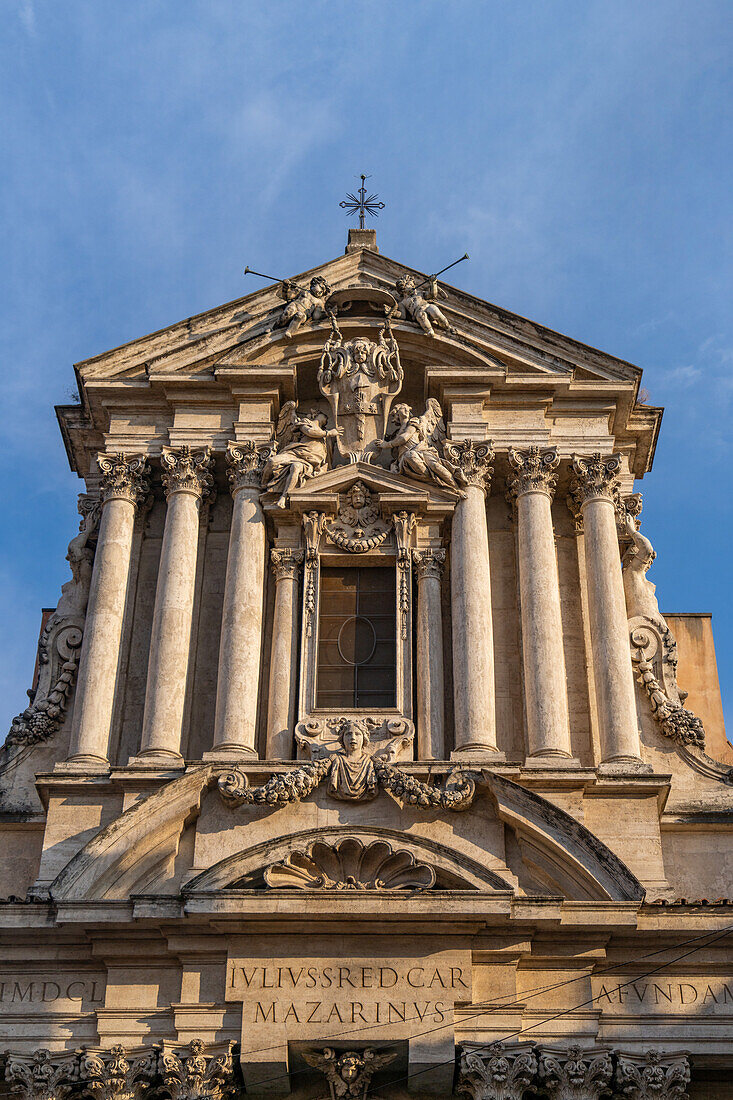 Facade of the Church of Saints Vincent and Anastasio on the Piazza di Trevi in Rome, Italy.