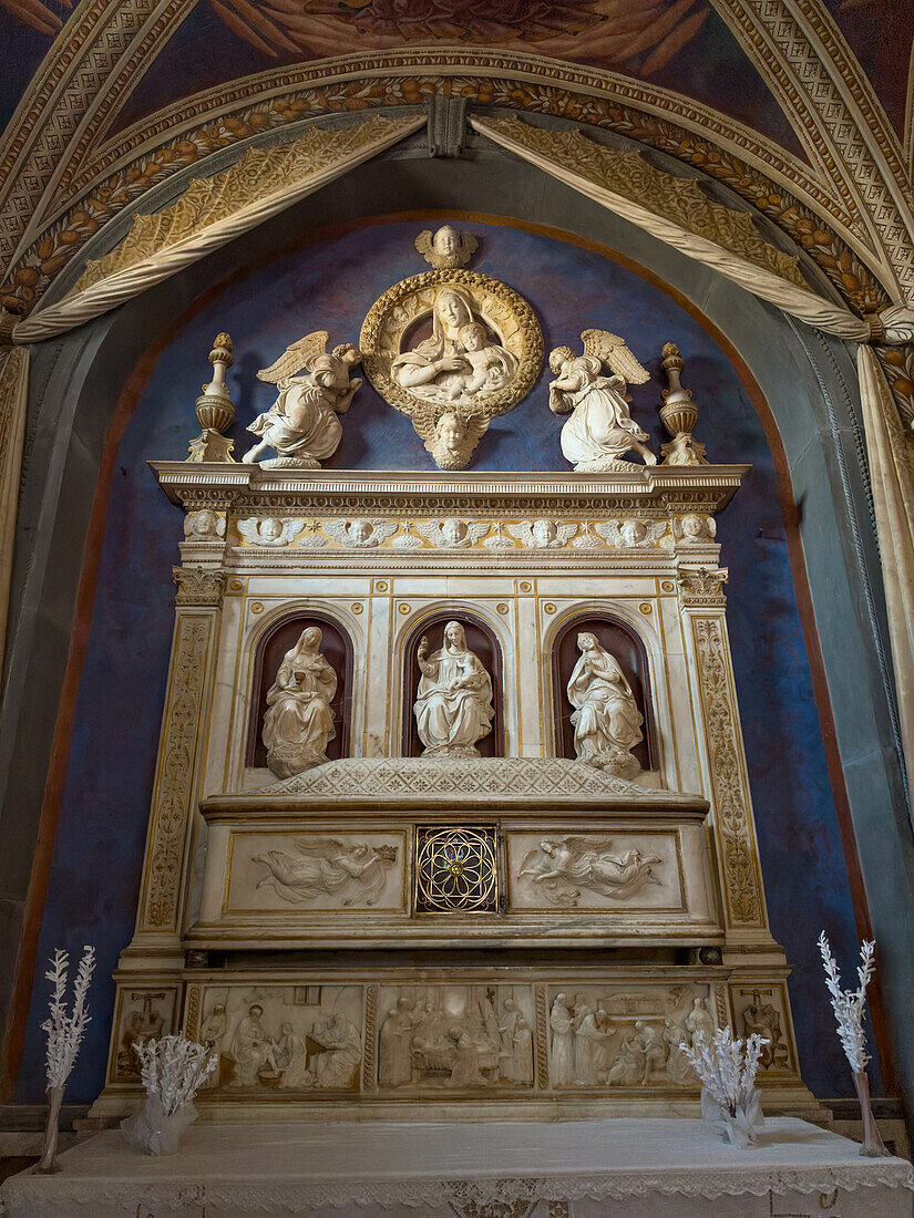 15th Century marble altar in the Chapel of San Bartolo in the Church of Sant'Agostino in Gimignano, Italy. The altar was carved by Benedetto da Maiano. The remains of San Bartolo are inside the altar.