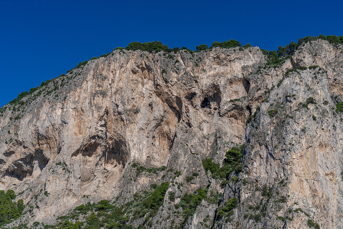 Stalactites in grottos in the limestone cliffs on the coast of the island of Capri, Italy.