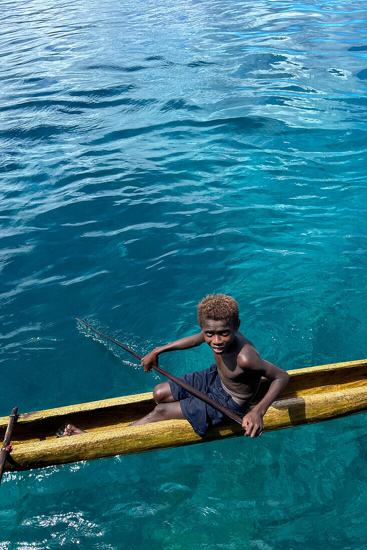 Residents of Tungelo Island in their traditional dugout canoes, New Ireland province, Papua New Guinea