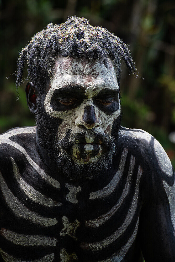 The Skeleton Men from the Omo Bugamo tribe of Papua New Guinea paint their bodies with black and white paint emulating the human skeleton, Chimbu Province, Papua New Guinea