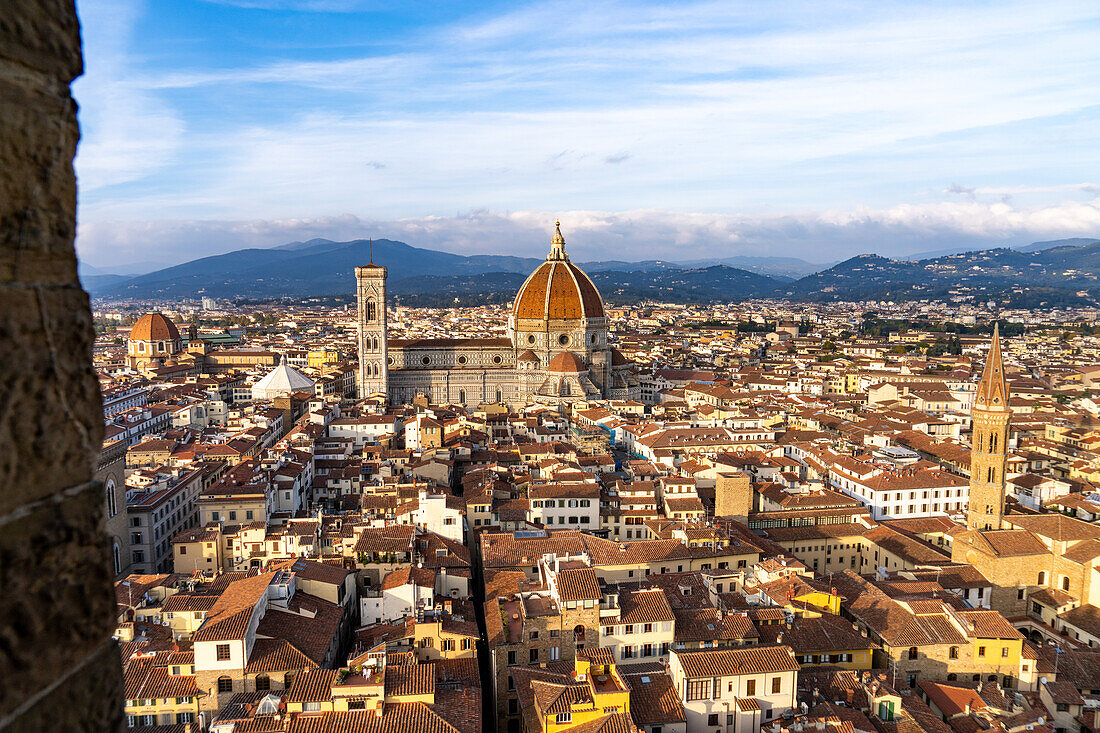 View of the Duomo or Cathedral of Santa Maria del Fiore from the Palazzo Vecchio tower in Florence, Italy. At right is the tower of the Badia Fiorentina.