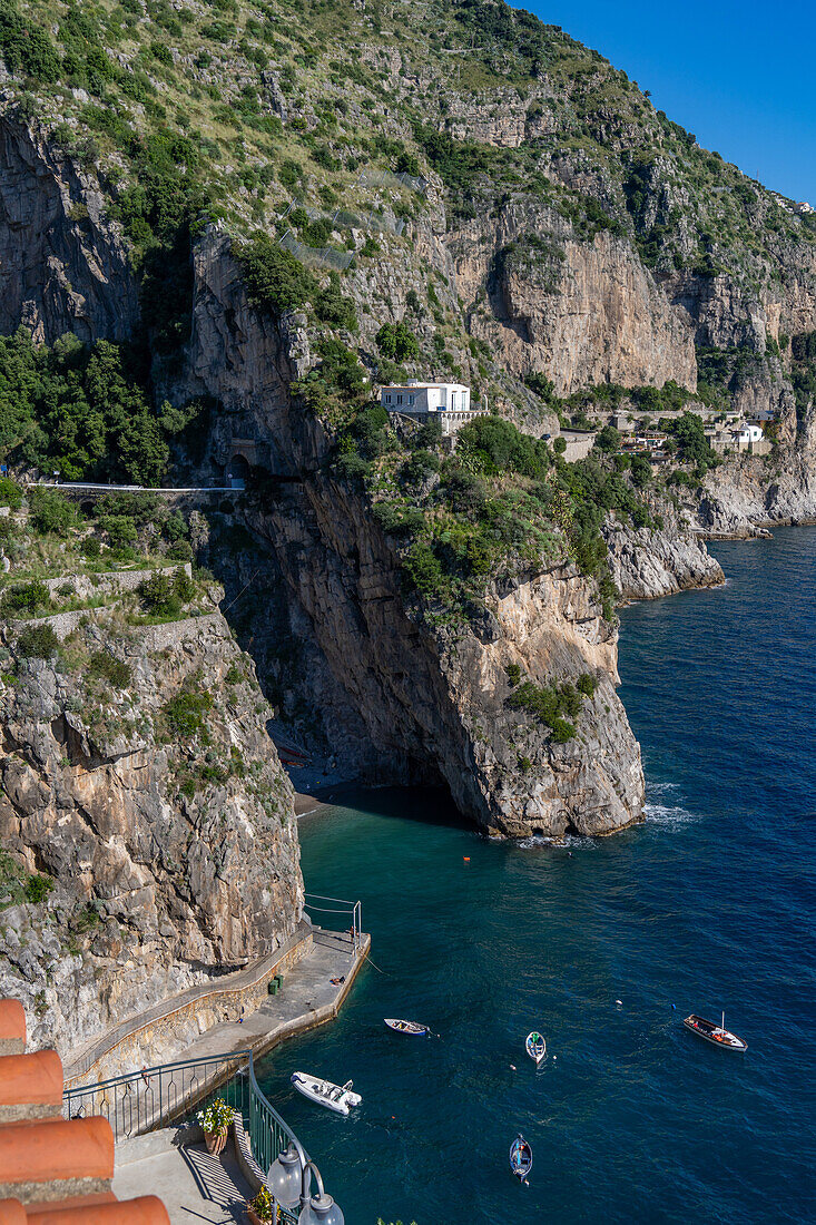 Boats moored in front of the Marina di Praia by the Amalfi Coast resort town of Praiano, Italy.