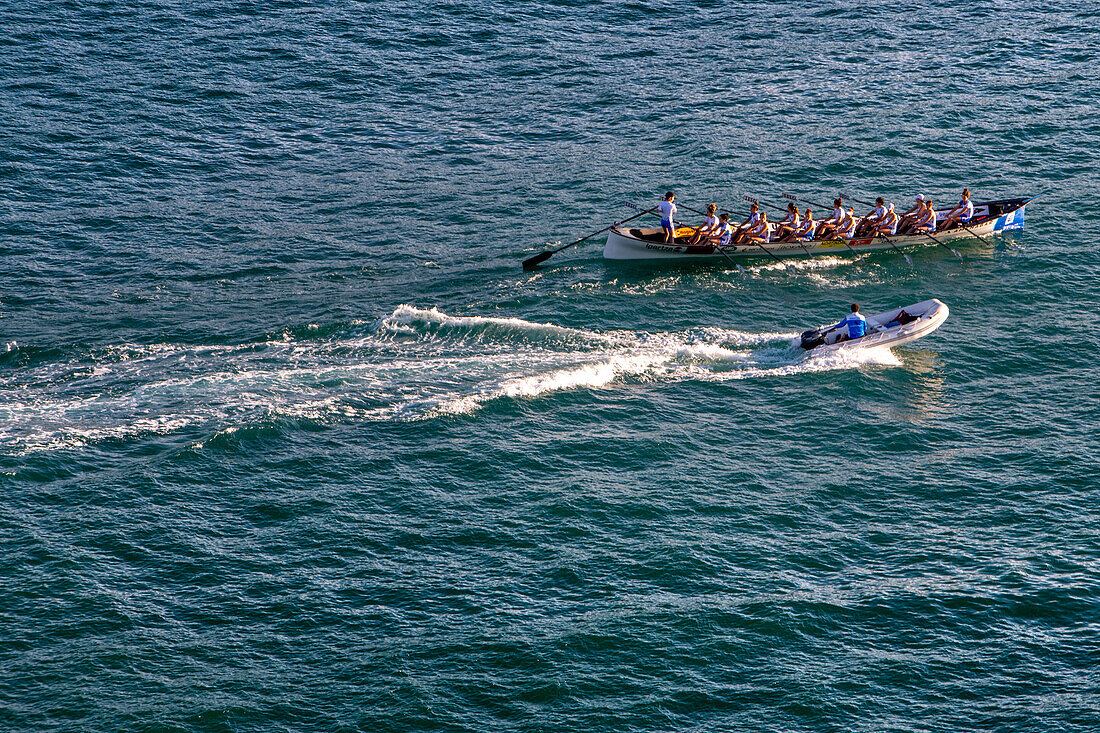 Trainera rowing boat regatta in the bay of La Concha in San Sebastian during Eusko Label and Euskotren 2023 league in San Sebastian, Gipuzkoa, Donostia San Sebastian city, north of Spain, Euskadi, Euskaerria, Spain. Hotel Londres (London) first building on right overlooking beach.