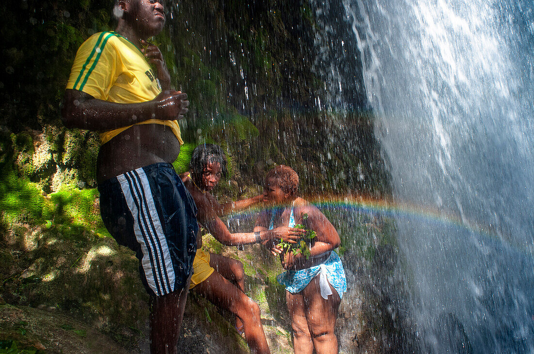 Haiti Voodoo Festival in Saut d'Eau, in Saut d'Eau, Ville Bonheur, Haiti. Thousands of both Vodou and Catholic followers gathered under the Saut d'Eau waterfall in Haiti. The pilgrimage, made by Voodou practitioners and Catholics alike, originated with the sighting of the likeness of the Virgin Mary on a palm leaf close to the falls half a century ago. Catholism and Voodou practices are forever intertwined in its Haitian form. The appearance of a rainbow beneath the falls is said indicate that Danbala - the great lord of the waterfall - and Ayida Wedo - the rainbow - are making love. Fertility