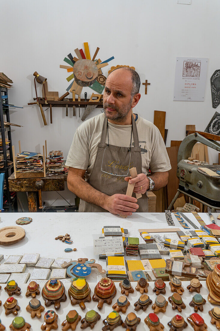 Handwerksmeister Antonino Guarracino bei der Arbeit an Holzintarsien und Laminatschmuck in Sorrento, Italien.