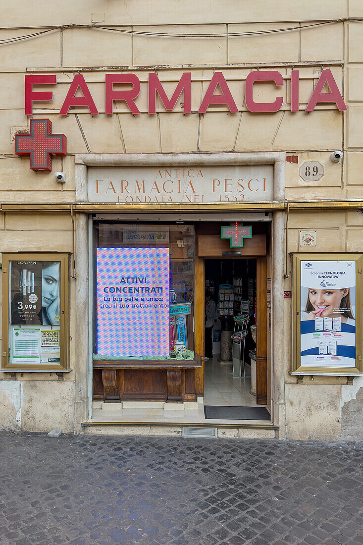 Facade of a pharmacy founded in 1552 on the Piazza di Trevi in Rome, Italy.