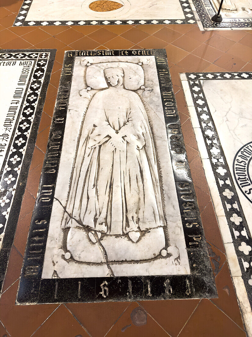 A medieval tomb in the floor of the Basilica of Santa Croce, Florence, Italy.