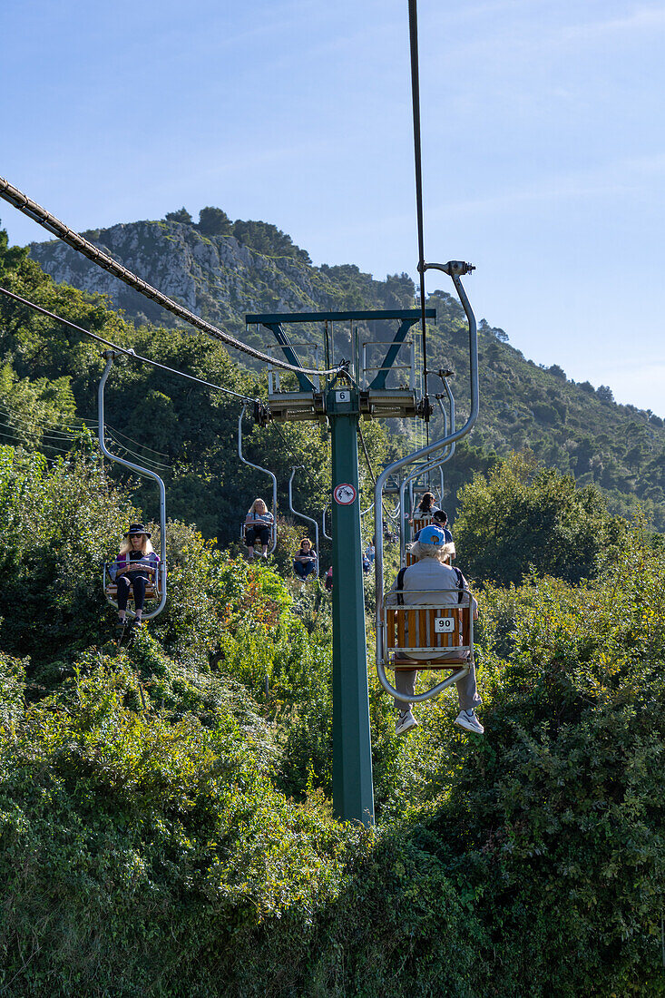 Tourists on the Monte Solaro chairlift from Anacapri to the Monte Solaro overlook on the island of Capri, Italy.