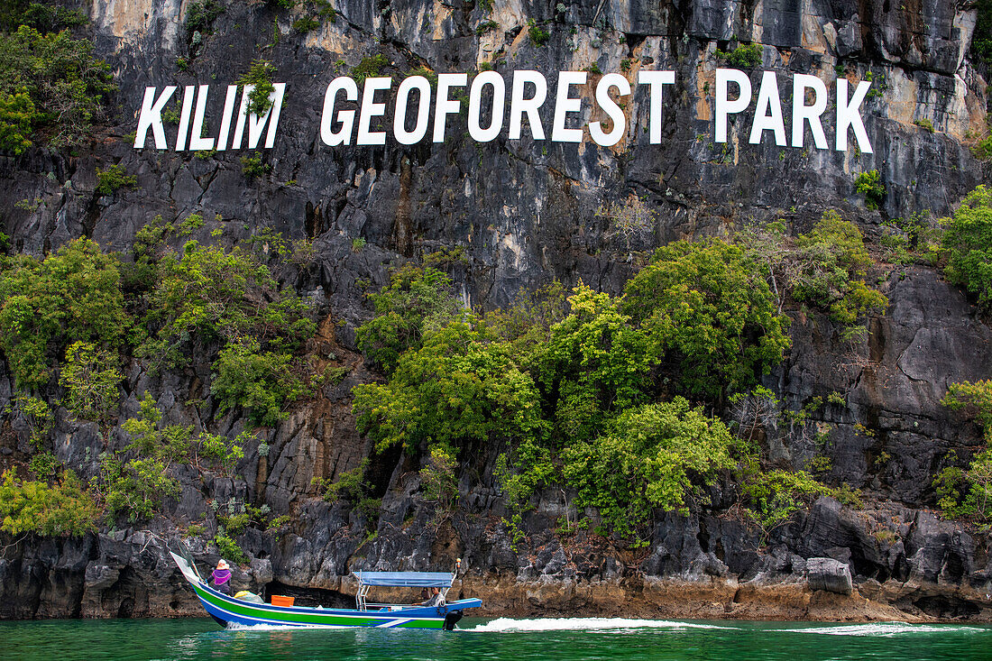 Boat trip at the Kilim Geoforest Park Jetty. Tourist boat starts their journey throw the mangrove forest. Island most exquisite and geologically significant landscapes