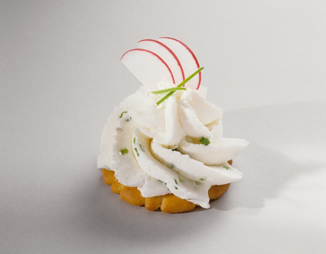 A Cracker Topped with Cream Cheese and Chives