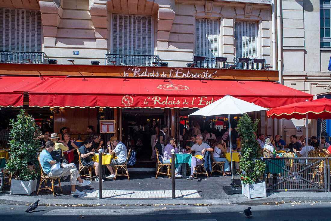 Le Relais de lEntrecote is traditional French restaurant decorated for Christmas. It located in historical centre of Paris near Champs Elysees avenue