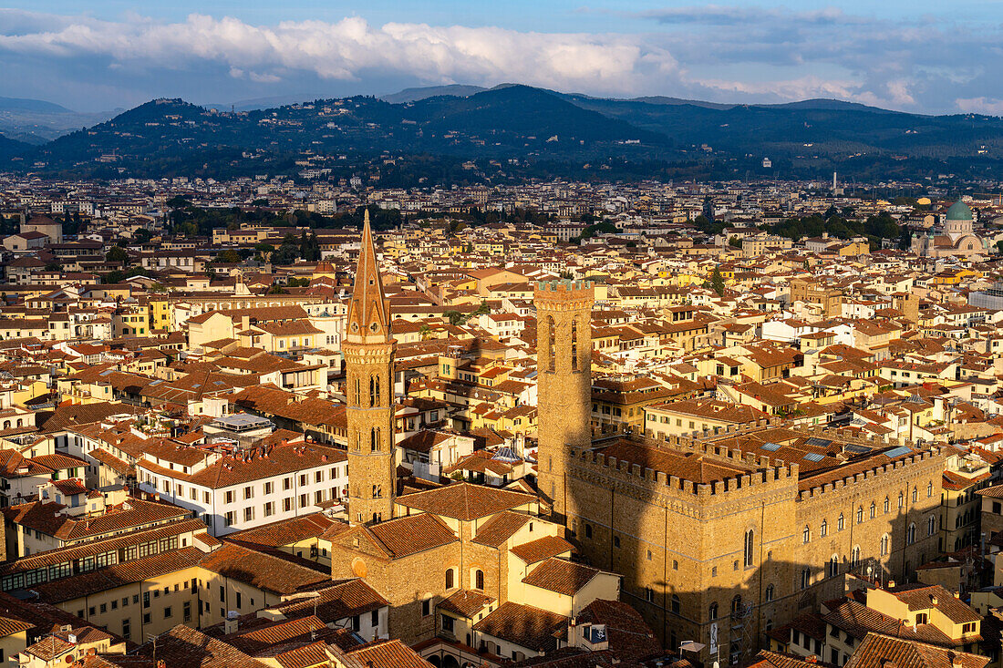 View of the towers of the Badia Fiorentina & Palazzo del Bargello seen from the Palazzo Vecchio tower in Florence, Italy. The shadow of the Palazzo Vecchio tower is projected onto the Palazzo del Bargello.